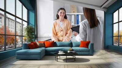 medicine, healthcare and people concept - female doctor with tablet pc computer talking to smiling woman patient at hospital Wall mural