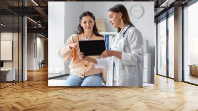 medicine, healthcare and people concept - female doctor with tablet pc computer talking to woman patient at hospital Wall mural