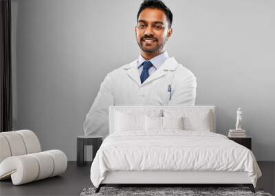 medicine, science and profession concept - smiling indian male doctor or scientist in white coat over grey background Wall mural