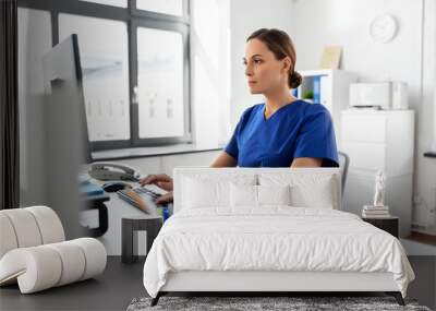 medicine, technology and healthcare concept - female doctor or nurse with computer working at hospital Wall mural