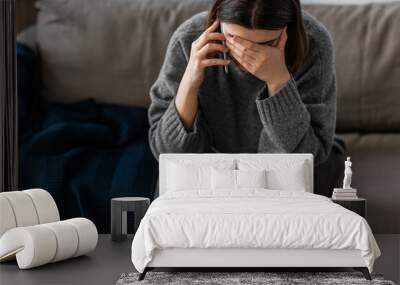 mental health, psychological help and depression concept - close up of stressed woman calling on phone at home Wall mural