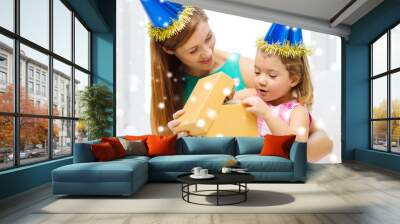 mother and daughter in party hats with gift box Wall mural