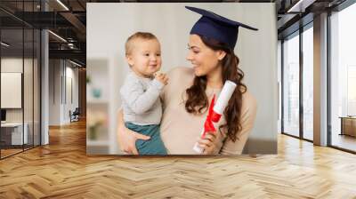 mother student with baby boy and diploma at home Wall mural