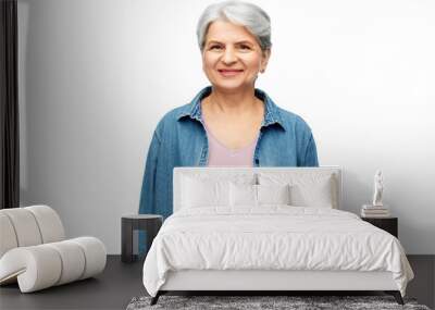 old people concept - portrait of smiling senior woman in denim shirt over white background Wall mural