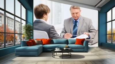 older man and young man having meeting in office Wall mural