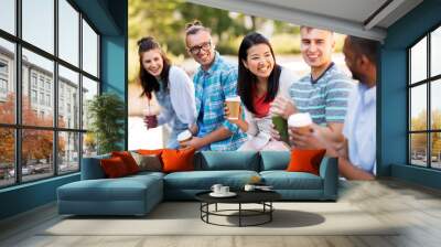 people, friendship and international concept - group of happy friends drinking coffee and juice talking in city Wall mural