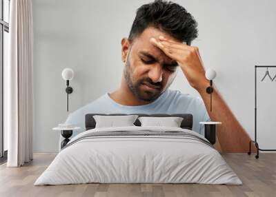 people, health problem and stress concept - unhappy indian man suffering from headache over grey background Wall mural