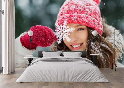 people, season and christmas concept - portrait of happy smiling teenage girl or young woman with snowflake in winter park Wall mural