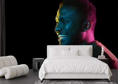 people and ethnicity concept - portrait of happy smiling young african american man over black background Wall mural