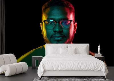 people and ethnicity concept - portrait of young african american man in glasses over black background Wall mural