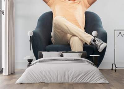 people and furniture concept - happy smiling young indian man sitting in chair over grey background Wall mural