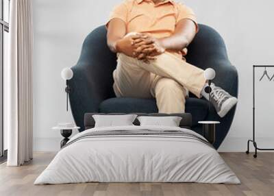 people and furniture concept - happy smiling young indian man sitting in chair over grey background Wall mural