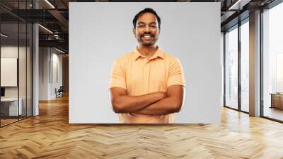 people and furniture concept - portrait of happy smiling young indian man with crossed arms over grey background Wall mural