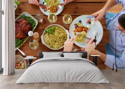 people at table with food eating pasta for dinner Wall mural