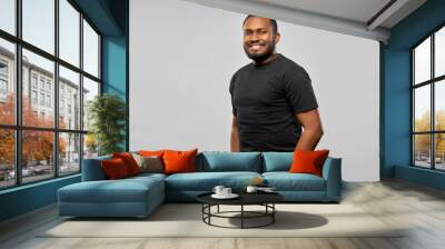 people concept - happy smiling young african american man in black t-shirt over grey background Wall mural