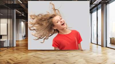 people concept - smiling teenage girl in red t-shirt with long hair waving over grey background Wall mural