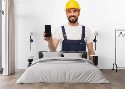 profession, construction and building - happy smiling male worker or builder in yellow helmet and overall showing smartphone over white background Wall mural