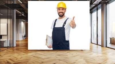 profession, construction and building - happy smiling male worker or builder in yellow helmet and overall with clipboard showing thumbs up over white background Wall mural