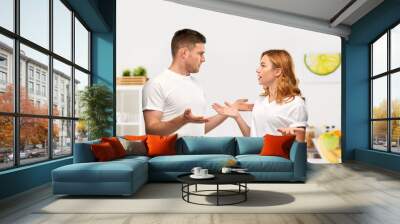 relationship difficulties, conflict and emotions concept - unhappy couple having argument over home kitchen background Wall mural