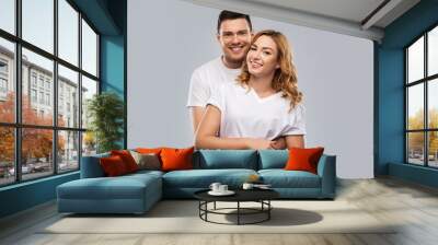 relationships and people concept - portrait of happy couple in white t-shirts over grey background Wall mural