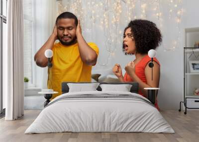 relationships and people concept - unhappy african american couple having argument over home bedroom background Wall mural