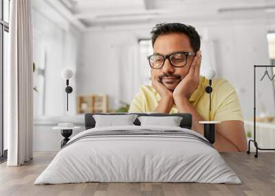 remote job, technology and people concept - bored young indian man in glasses with laptop computer working at home office Wall mural