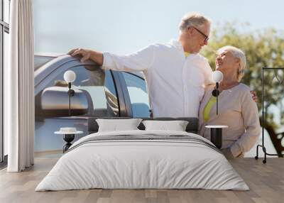 road trip, travel and old people concept - happy senior couple with car in summer Wall mural