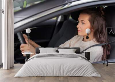 safety and people concept - young woman or female driver driving car in city Wall mural