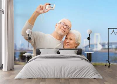 senior couple with camera over rainbow bridge Wall mural