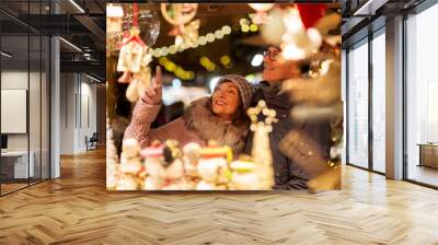 shopping, winter holidays and people concept - happy senior couple at christmas market souvenir shop on town hall square in tallinn, estonia Wall mural