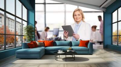 smiling businesswoman with tablet pc at office Wall mural