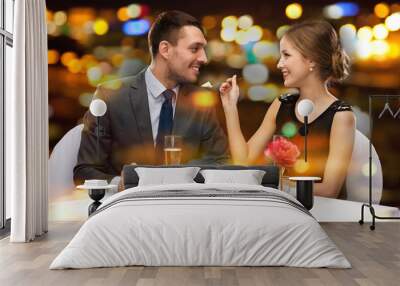 smiling couple eating dessert at restaurant Wall mural