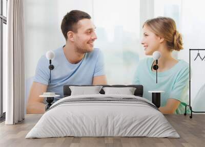 smiling couple having breakfast at home Wall mural