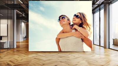 smiling couple having fun over sky background Wall mural