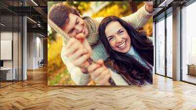 smiling couple hugging in autumn park Wall mural