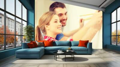 smiling couple measuring wall Wall mural