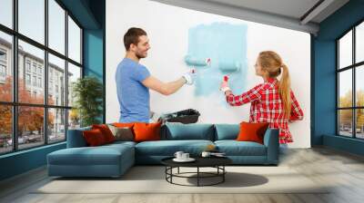 smiling couple painting wall at home Wall mural