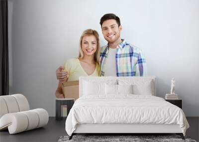 smiling couple with box moving to new home Wall mural