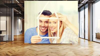 smiling couple with house from measuring tape Wall mural