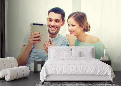 smiling couple with tablet pc reading news Wall mural