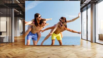 smiling friends having fun on summer beach Wall mural