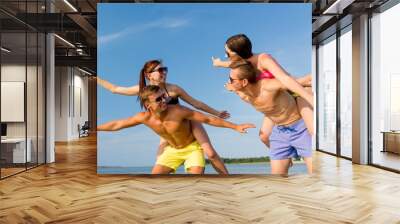 smiling friends having fun on summer beach Wall mural