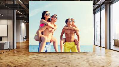 smiling friends in sunglasses on summer beach Wall mural