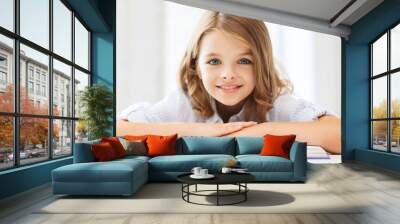 smiling little student girl with many books Wall mural