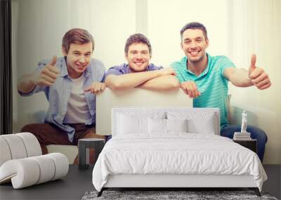 smiling male friends holding white blank board Wall mural