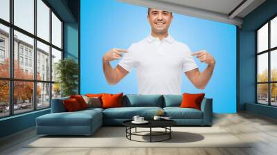 smiling man in t-shirt pointing fingers on himself Wall mural