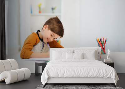 smiling student boy writing to notebook at home Wall mural