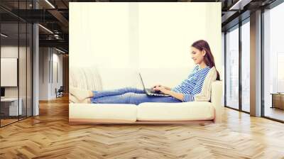 smiling teenage girl with laptop computer at home Wall mural