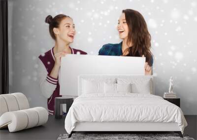 smiling teenage girls holding white blank board Wall mural