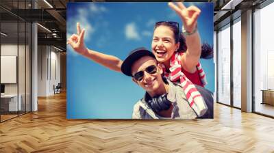 smiling teenagers in sunglasses having fun outside Wall mural